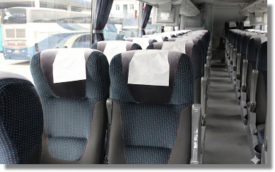 Interior moderno de VivaBus mostrando cómodos asientos oscuros reclinables con amplio espacio para las piernas